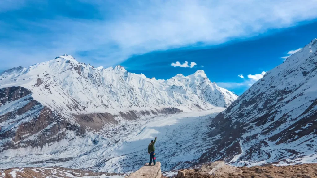Hiker on snowy ridge in the Pyrenees.