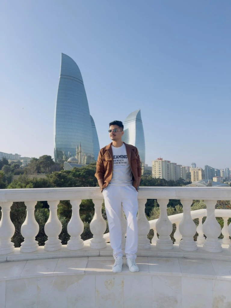 Traveler posing with Flame Towers in Baku Azerbaijan