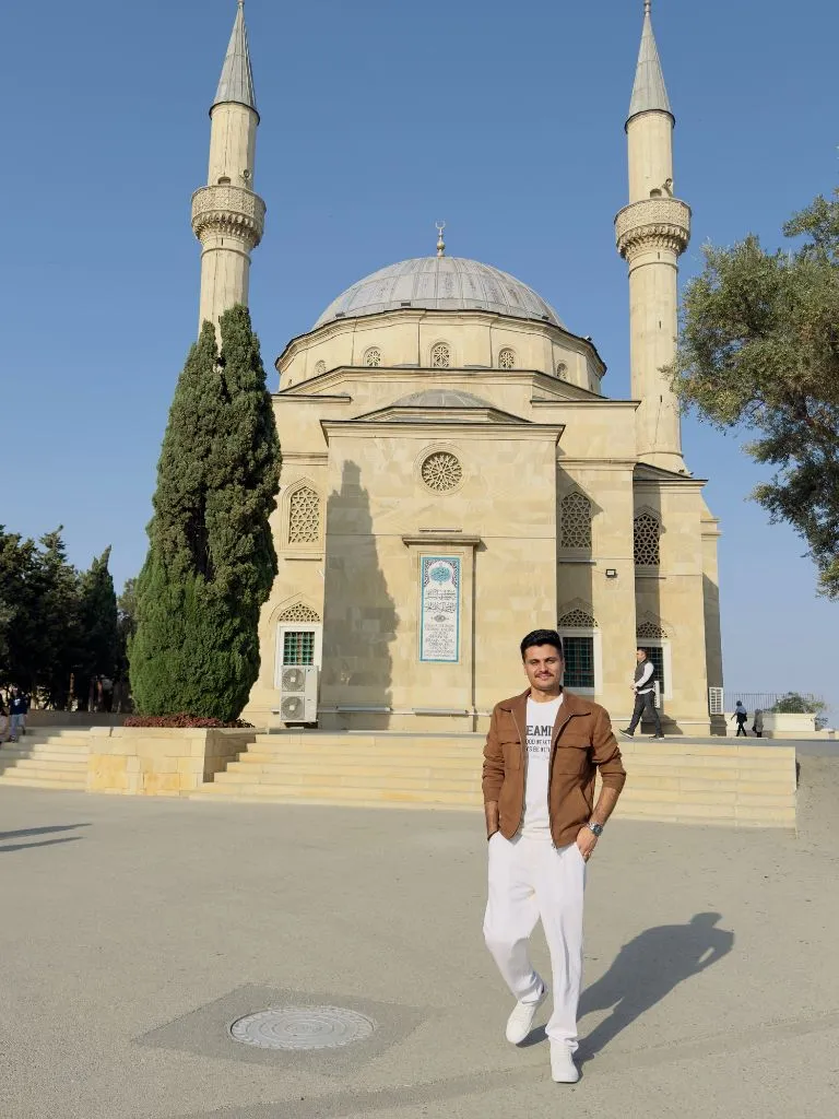 Traveler standing outside mosque near Baku Funicular and Highland Park