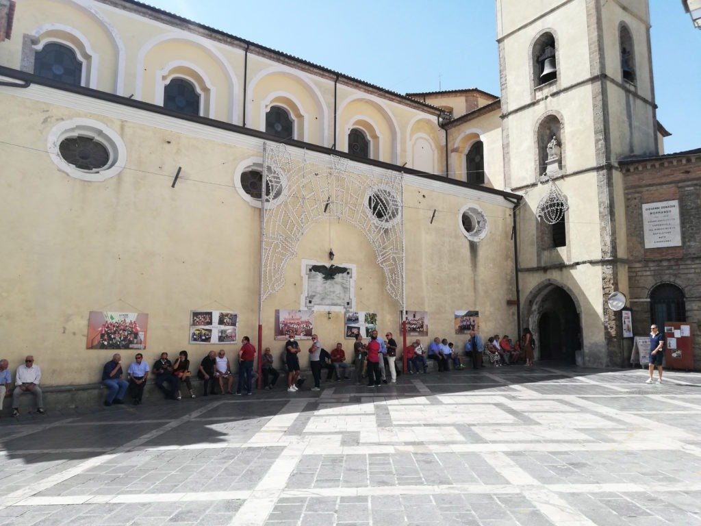 People gathered outside a historic church in Mormanno’s town square, Calabria